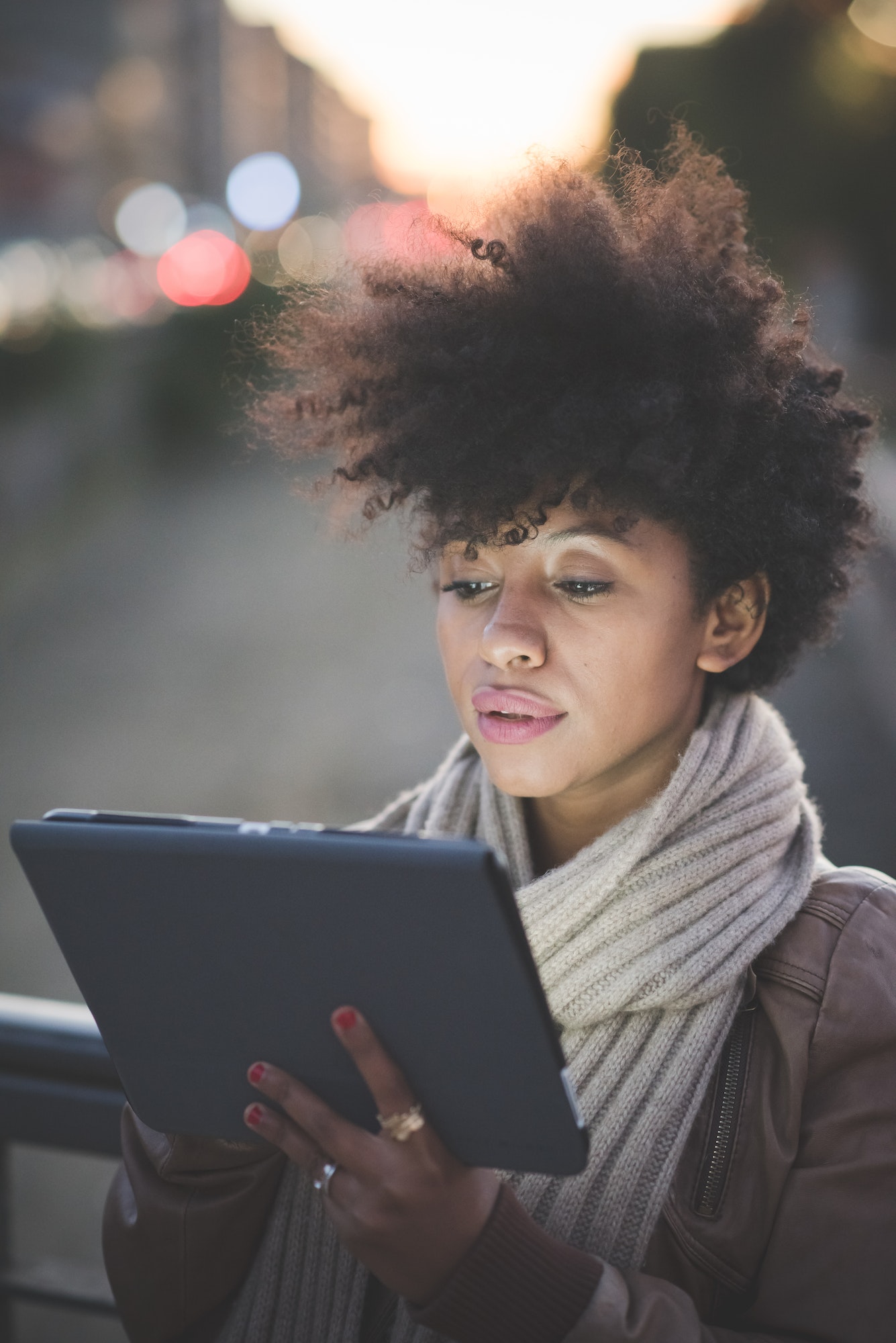 beautiful black curly hair african woman using tablet